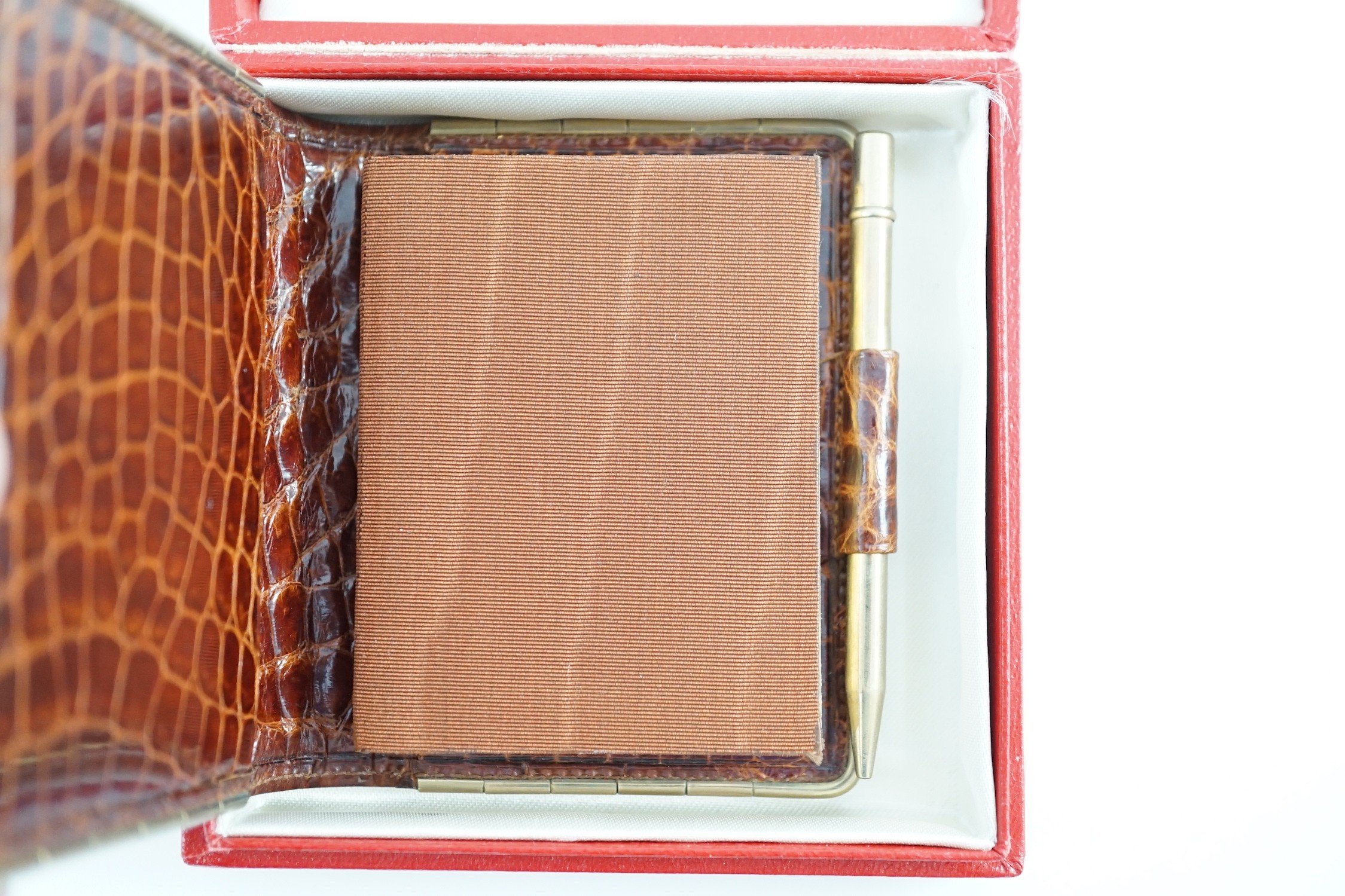 A boxed Cartier, London simulated crocodile notebook with silver pencil, unused